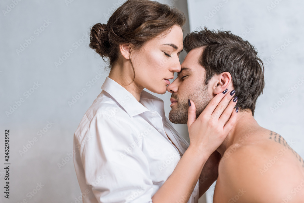 adult woman kissing man with passion and closed eyes adult woman kissing man with passion and closed eyes
