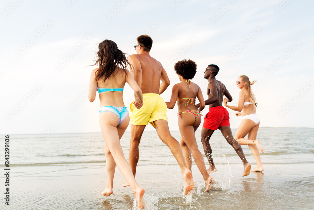 friendship, summer holidays and people concept - happy friends running on beach friendship, summer holidays and people concept - happy friends running on beach