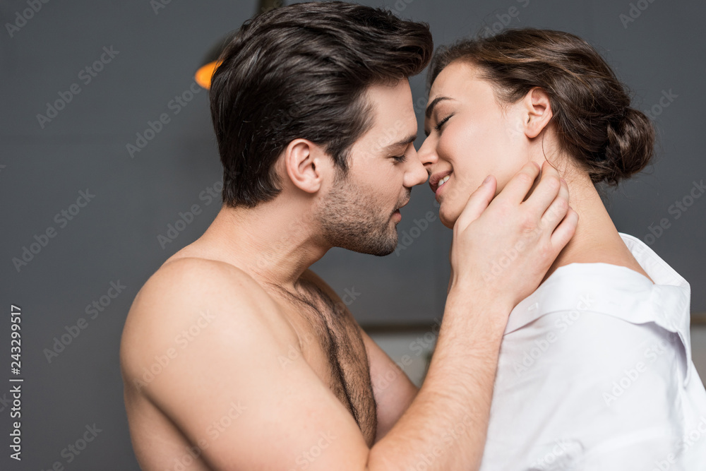 adult boyfriend gently touching girl and trying to kiss