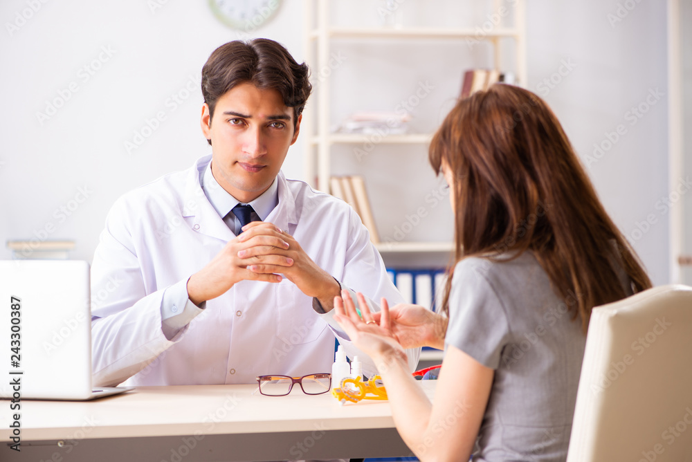 Young woman visiting male doctor ophthalmologist in hospital Young woman visiting male doctor ophthalmologist in hospital
