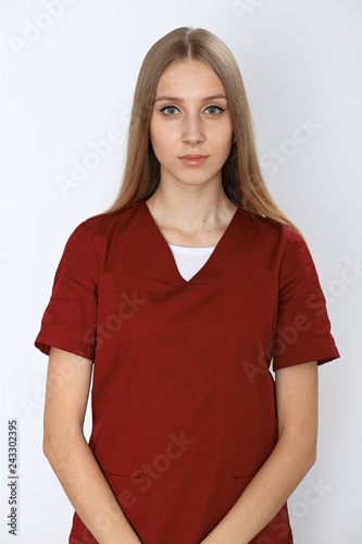 Smiling young nurse or surgeon portrait isolated over white background.