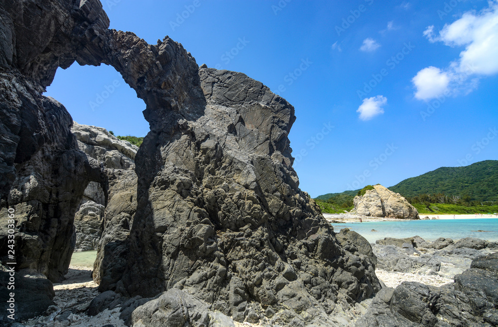 Natural rock arches along the coast at Aharen Beach on Tokashiki Island in Okinawa, Japan