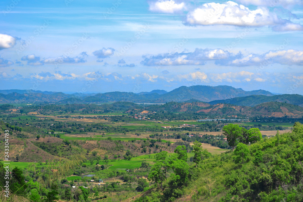 Vast landscape of Central Vietnam with distant mountains. Lush green vegetation.