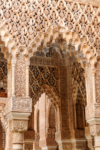 Interior in the courtyard of the lions in the Alhambra in Granada with architectural details.