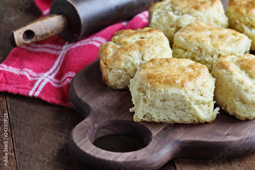 Fotografie Freshly baked buttermilk southern biscuits or scones from scratch over cutting board