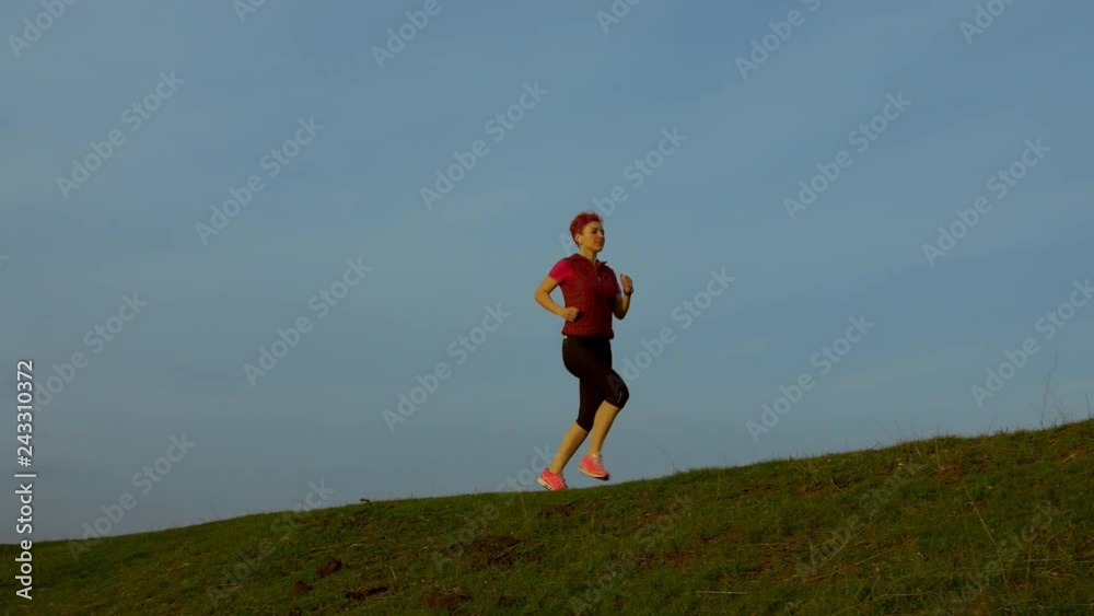 Young woman running outdoors at summer. Fitness runner girl training in park on amazing nature landscape. Fit athletic female working out for marathon run outside. Sport and health. Young woman running outdoors at summer. Fitness runner girl training in park on amazing nature landscape. Fit athletic female working out for marathon run outside. Sport and health.