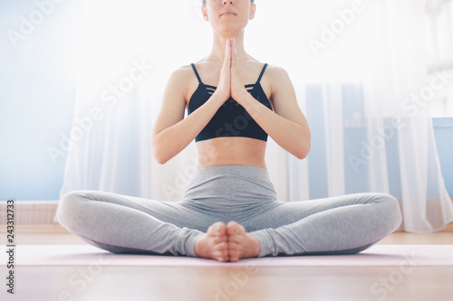 Woman practicing yoga. Lotus position. Healthy lifestyle concept.