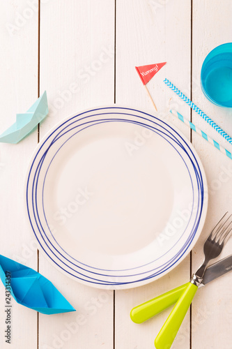 Table setting for kids - empty plate with decorations around