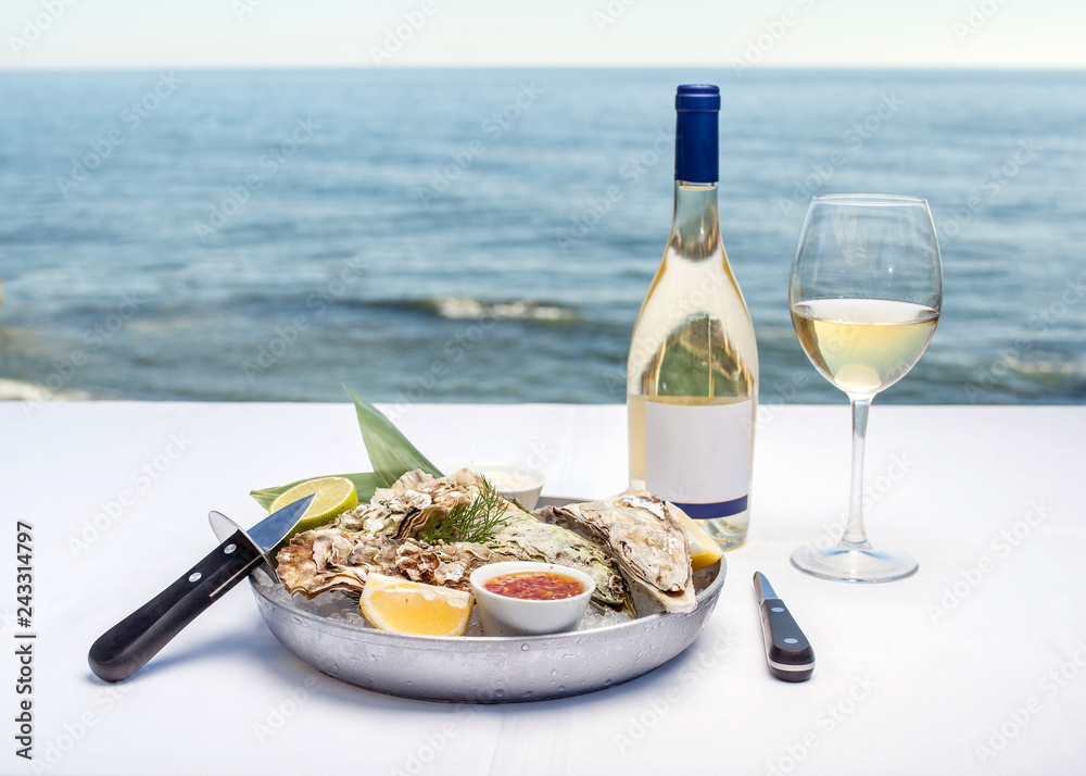 Oysters and wine overlooking the sea Oysters and wine overlooking the sea