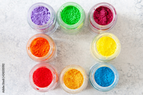 Bright colourful powdered pigments in glass bottles for Indian holi festival top view photo