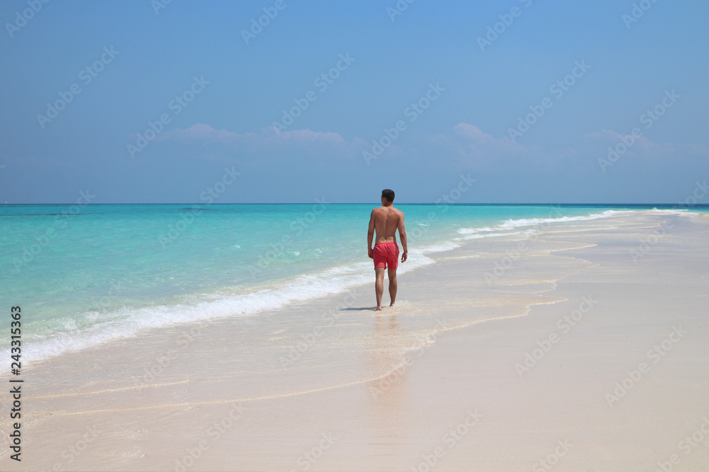 Lonesome Man walking on beach