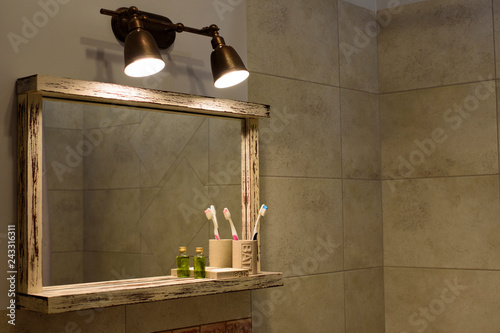 Sconce under the mirror in the bathroom - Image