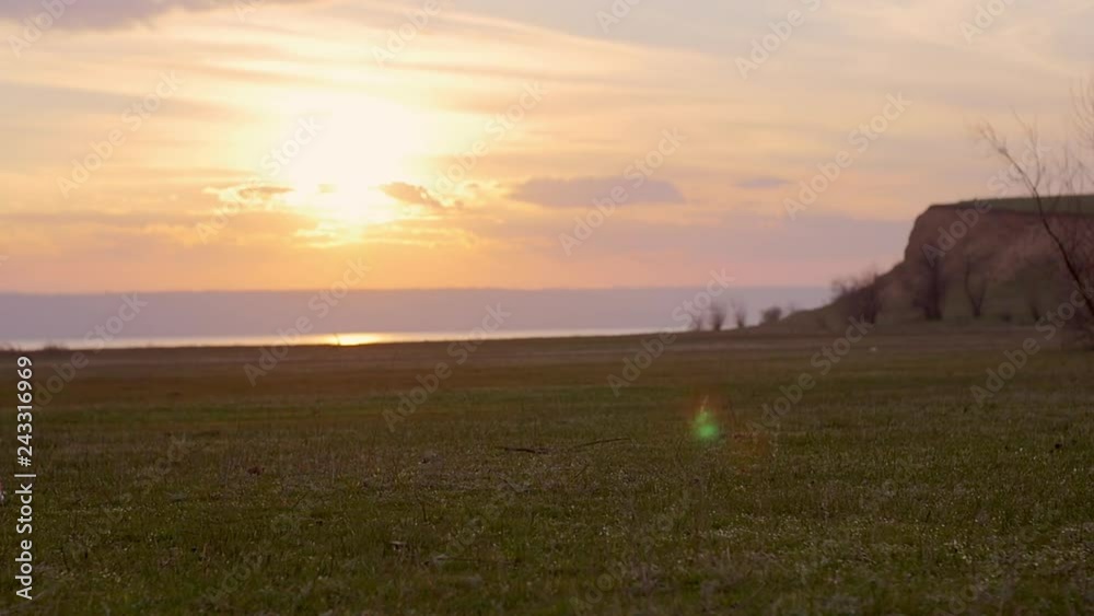 Young woman running at sunrise. Fitness runner girl training outdoors at sunset on amazing landscape nature. Fit athletic female working out for marathon, run outside. Sport and health. Slow motion.