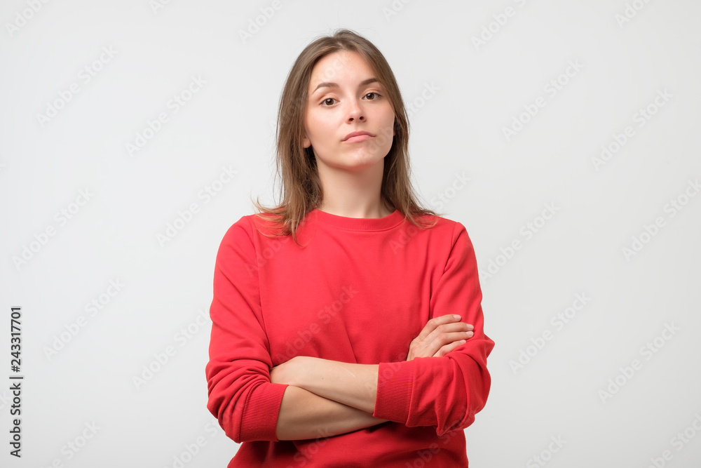 Fototapeta premium Young serious angry woman portrait on a white background