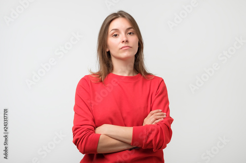 Young serious angry woman portrait on a white background