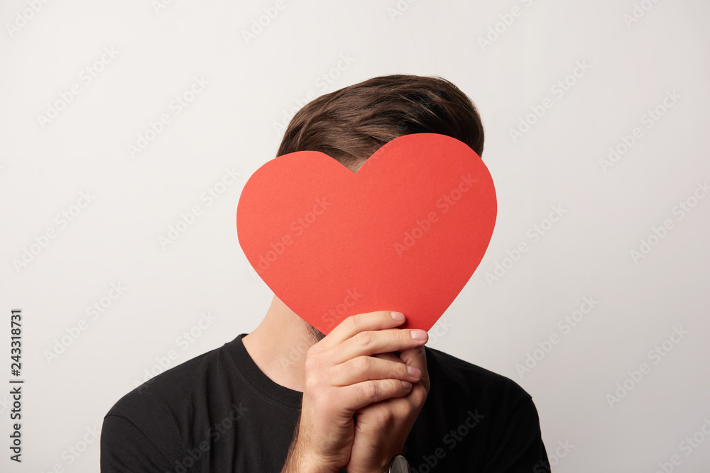 man in black with obscure face and empty paper cut heart card isolated on grey man in black with obscure face and empty paper cut heart card isolated on grey