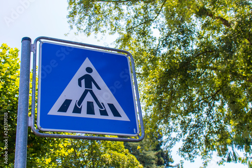 Blue Crosswalk sign at the street