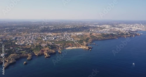 Aerial view of beautiful landscape and rocky beaches of Algarve coast in Portugal summertime.