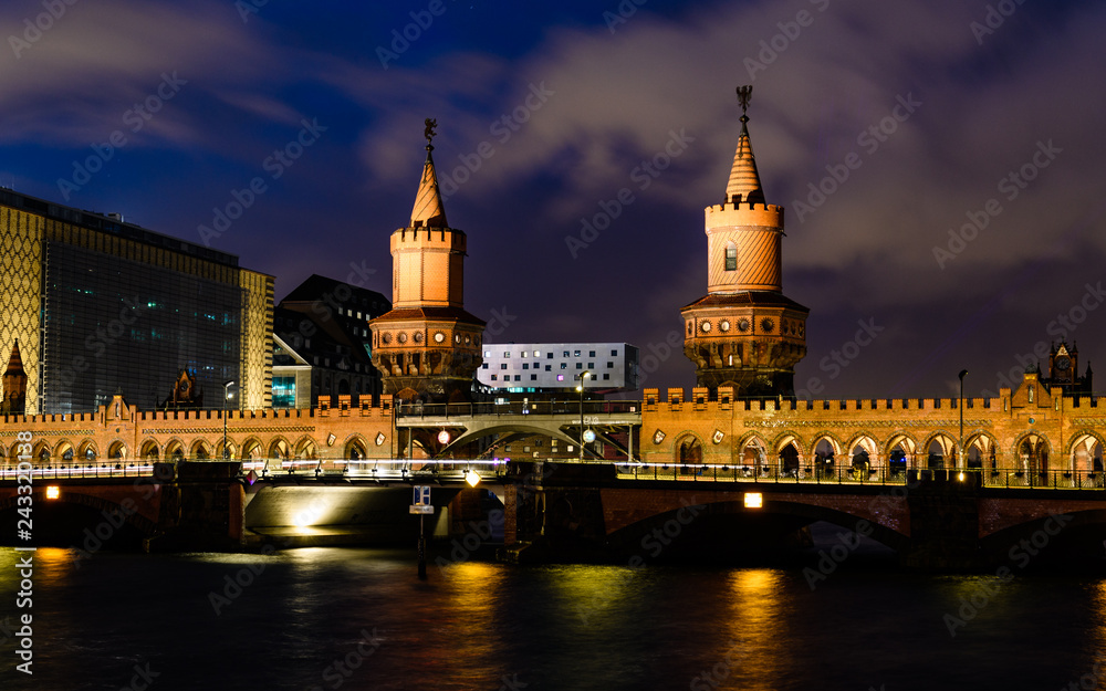 Bridge Oberbaum and Spree river in Berlin, Germany at night
