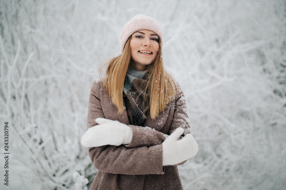 Portrait of smiling woman in hat on walk in winter forest Portrait of smiling woman in hat on walk in winter forest