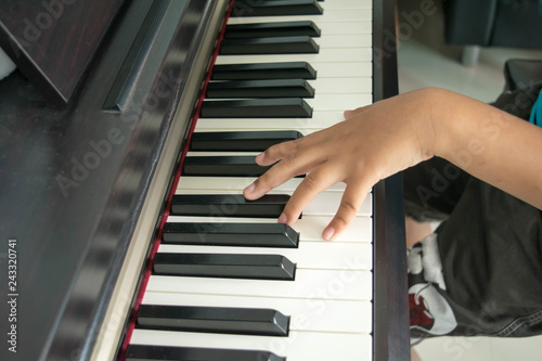 The boy hand is playing a piano instrument blur.