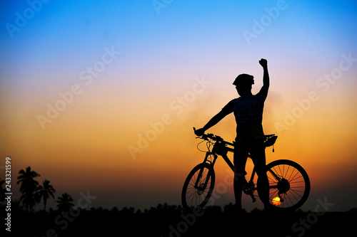 Silhouette of cyclist with mountain bike on beautiful sunset time.