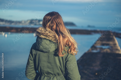 Young woman on the beach in winter