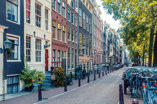 Photography Street scene from Amsterdam with typical architecture of row of buildings alongs