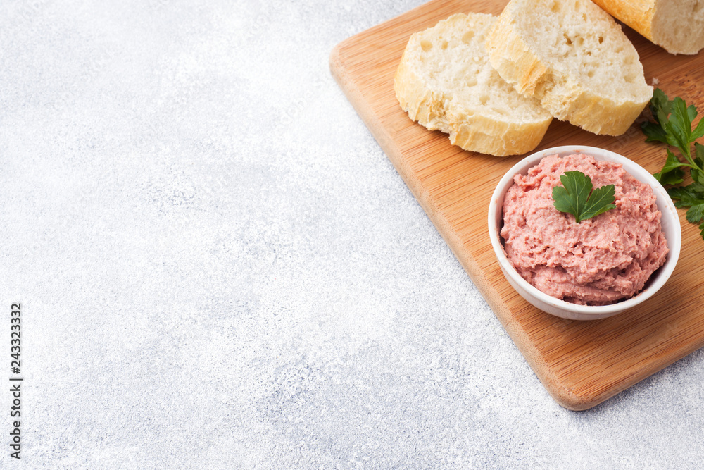 Baked chicken pate in a plate and pieces of bread on the Board. Copy space.