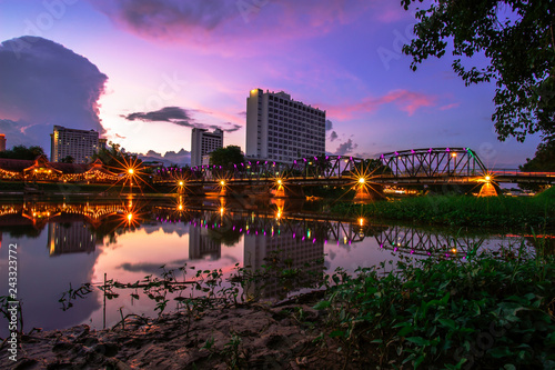 The landscape of the iron bridge across the Ping River in Chiang Mai in the twilight photo