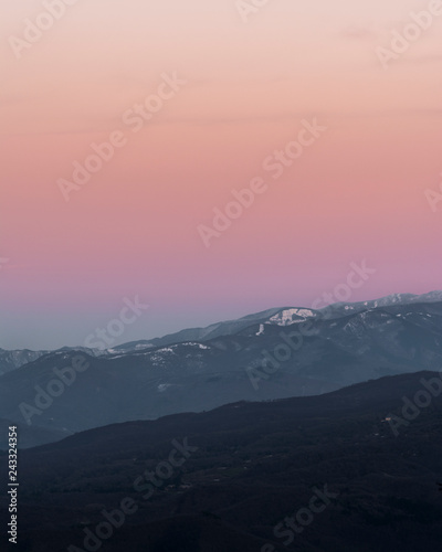 sunset in the mountains with snow in winter