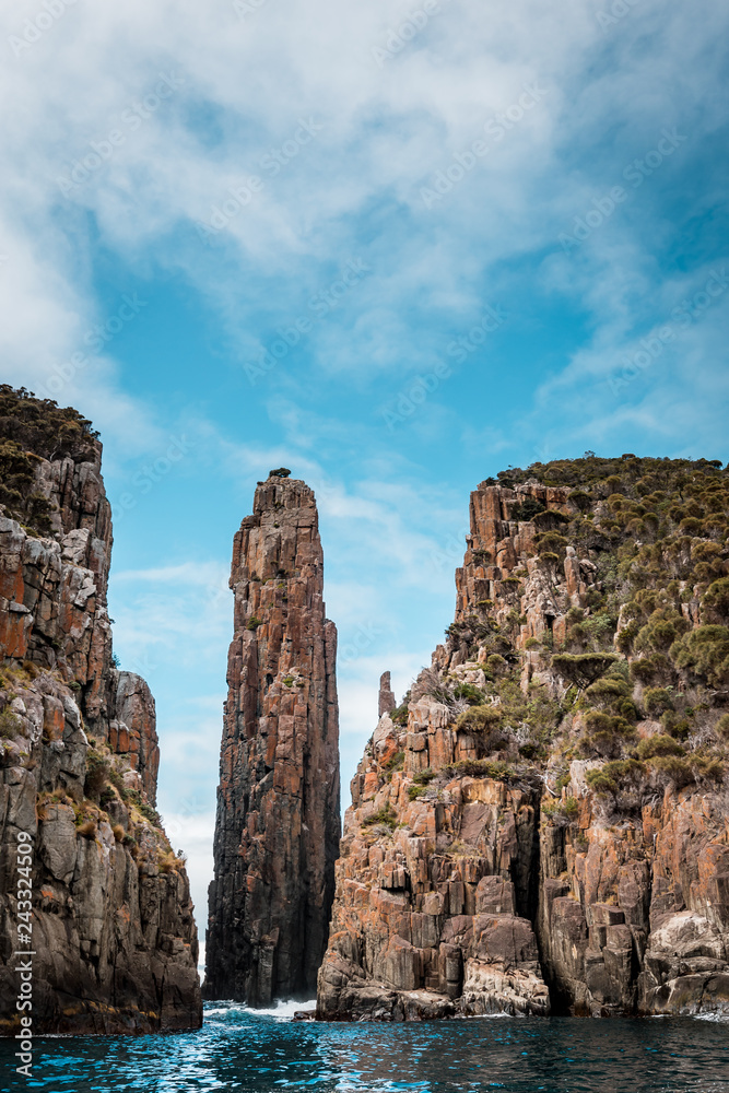 View to the Totem Pole of Cape Hauy, rough coastline with dolerite cliffs, Tasmania, Australia