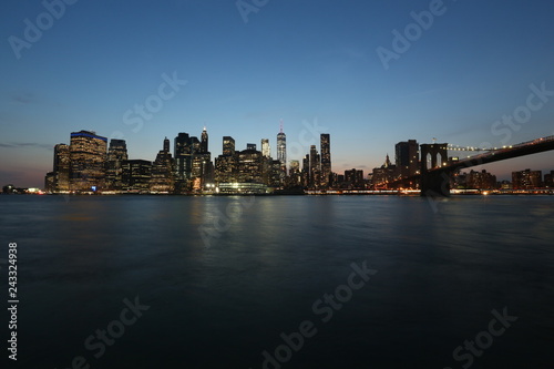 View from the sea on the evening of New York and the bridge