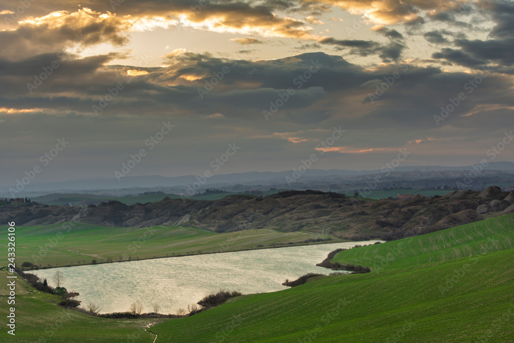 Fototapeta premium landscape with lake and hills, blue sky and clouds