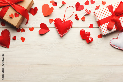 Obraz na plátne Valentine day background, handmade hearts and giftboxes on wood