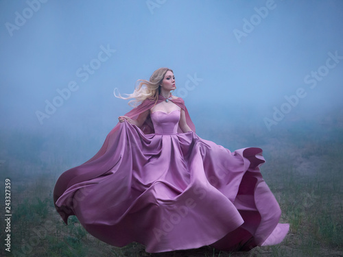 excellent mysterious blonde lady runs away from a nightmare, a forest monster, her light long expensive royal dress flutters on the fly, takes the form of a magical flower an amazing photo in motion