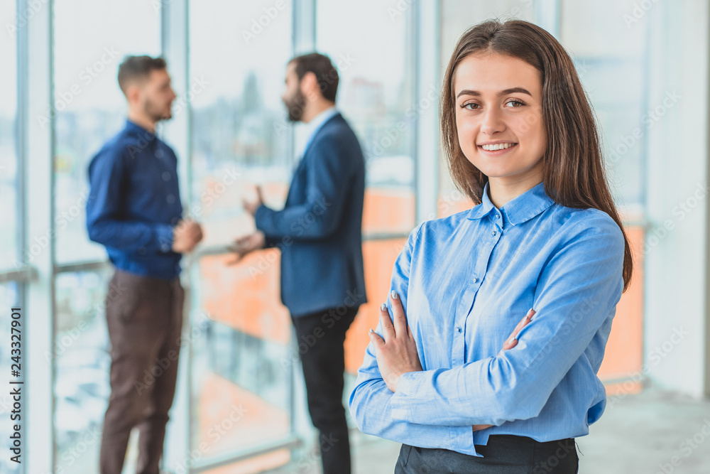 The secretary stands at the office by placing a hand on his hand from above. During this she is on the background of her colleagues. The secretary stands at the office by placing a hand on his hand from above. During this she is on the background of her colleagues.