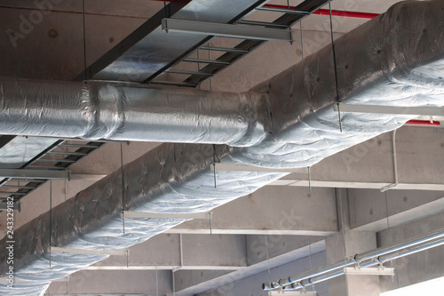 Typical installation of ducting with fiberglass insulation work combine with cable tray and fire fighting pipe