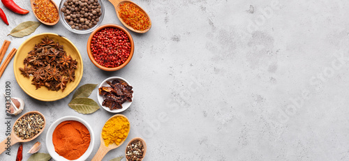 Fototapeta Naklejka Na Ścianę i Meble -  Dried spices and seasonings in bowls on grey background