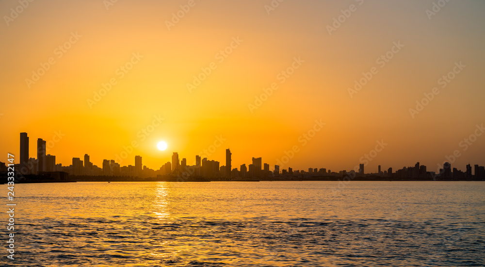 Skyline of Kuwait City at sunset.