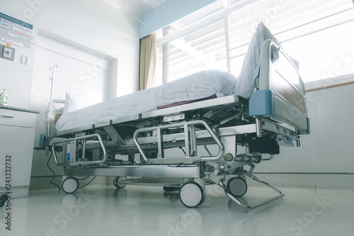 Empty hospital bed in hospital ward