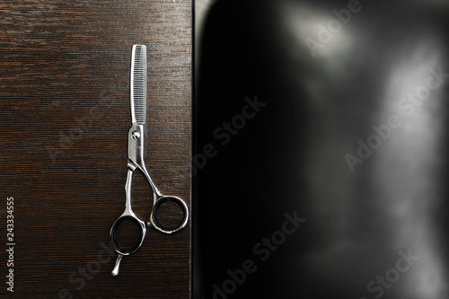 scissors for highlighting on a dark wooden table. Hairdressing Workspace. Work place for hairdresser. Professional Salon Supplies. Hair. Place for text. copy space