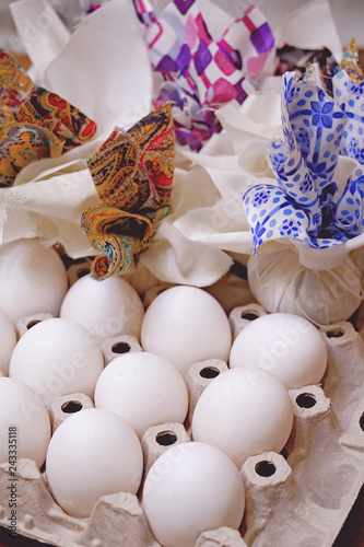 Chicken white eggs ready to decorate with pieces of colored fabric for Easter. Close-up.