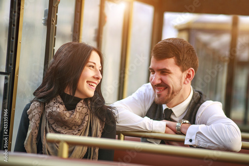 Young guy meets and talks to girl in tram public transport cabin