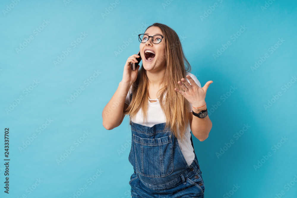 Excited pregnant woman talking at smartphone with a smiling surp Excited pregnant woman talking at smartphone with a smiling surp