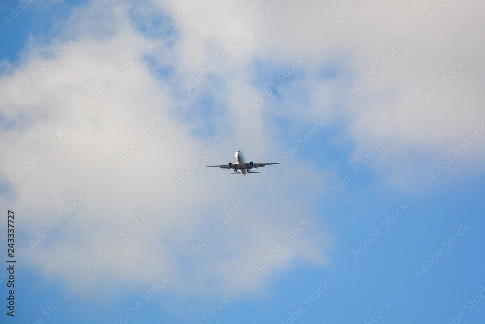 Passenger airplane landing against blue cloudy sky in Brazil Passenger airplane landing against blue cloudy sky in Brazil
