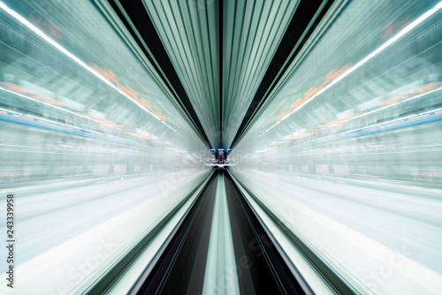 Motion blur of train moving inside tunnel with daylight in tokyo, Japan.