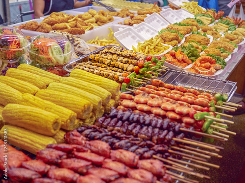 Street food on sticks in Phuket (Thailand). Corn cobs, pork, chicken, shrimp and other food.