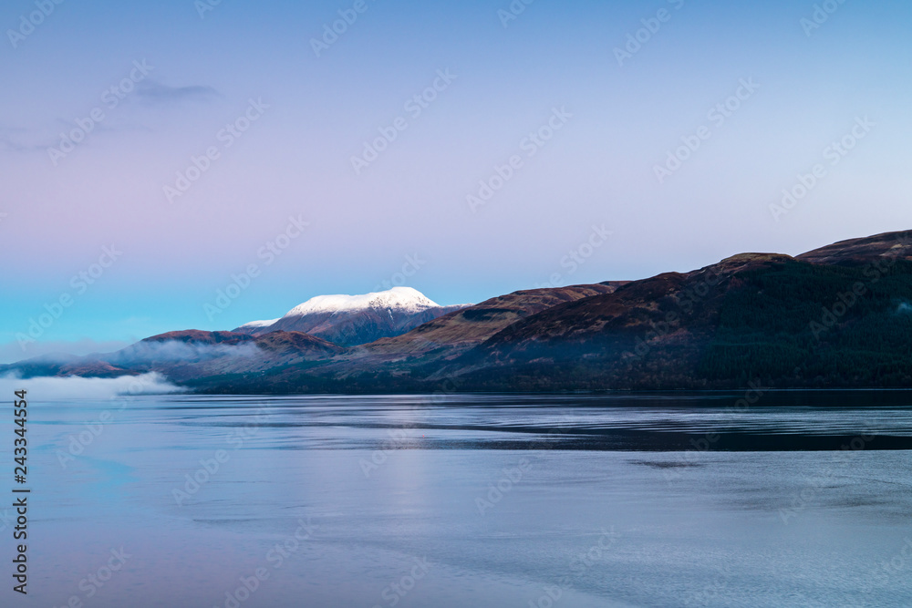 Mist on Loch Linnhe with a snowcapped Ben Nevis in the background.