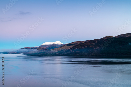 Mist on Loch Linnhe with a snowcapped Ben Nevis in the background.